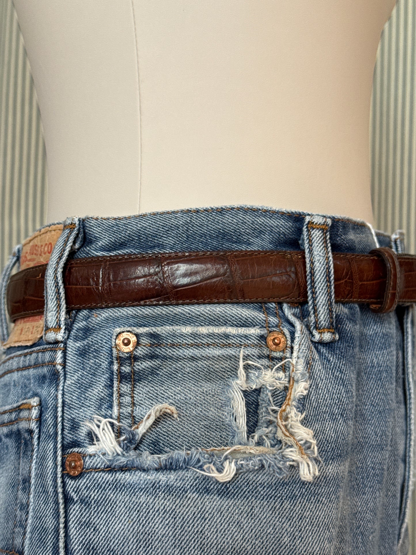 Brown leather belt with silver buckle