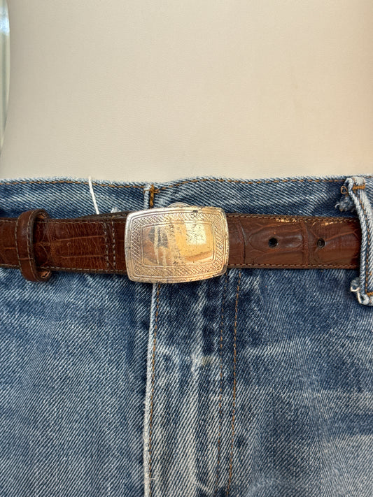 Brown leather belt with silver buckle